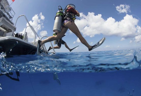 scuba-divers-enter-water-leaping-with-a-giant-stride-from-a-dive-boat-